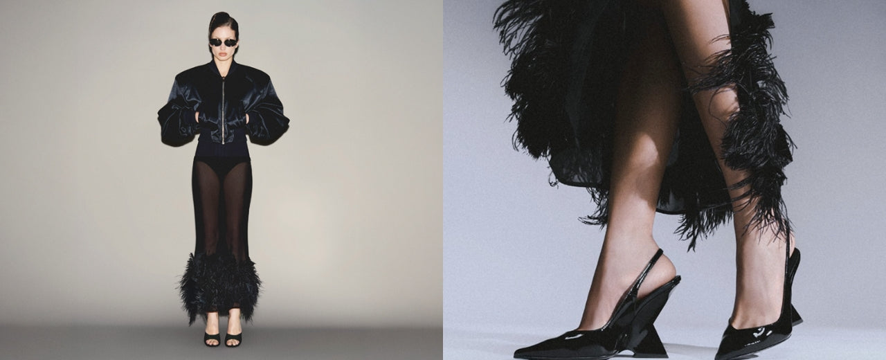 he Attico luxury fashion banner featuring a model in a sculptural black silhouette with feathered details and statement heels, showcasing the brand’s bold, glamorous and contemporary designer aesthetic.