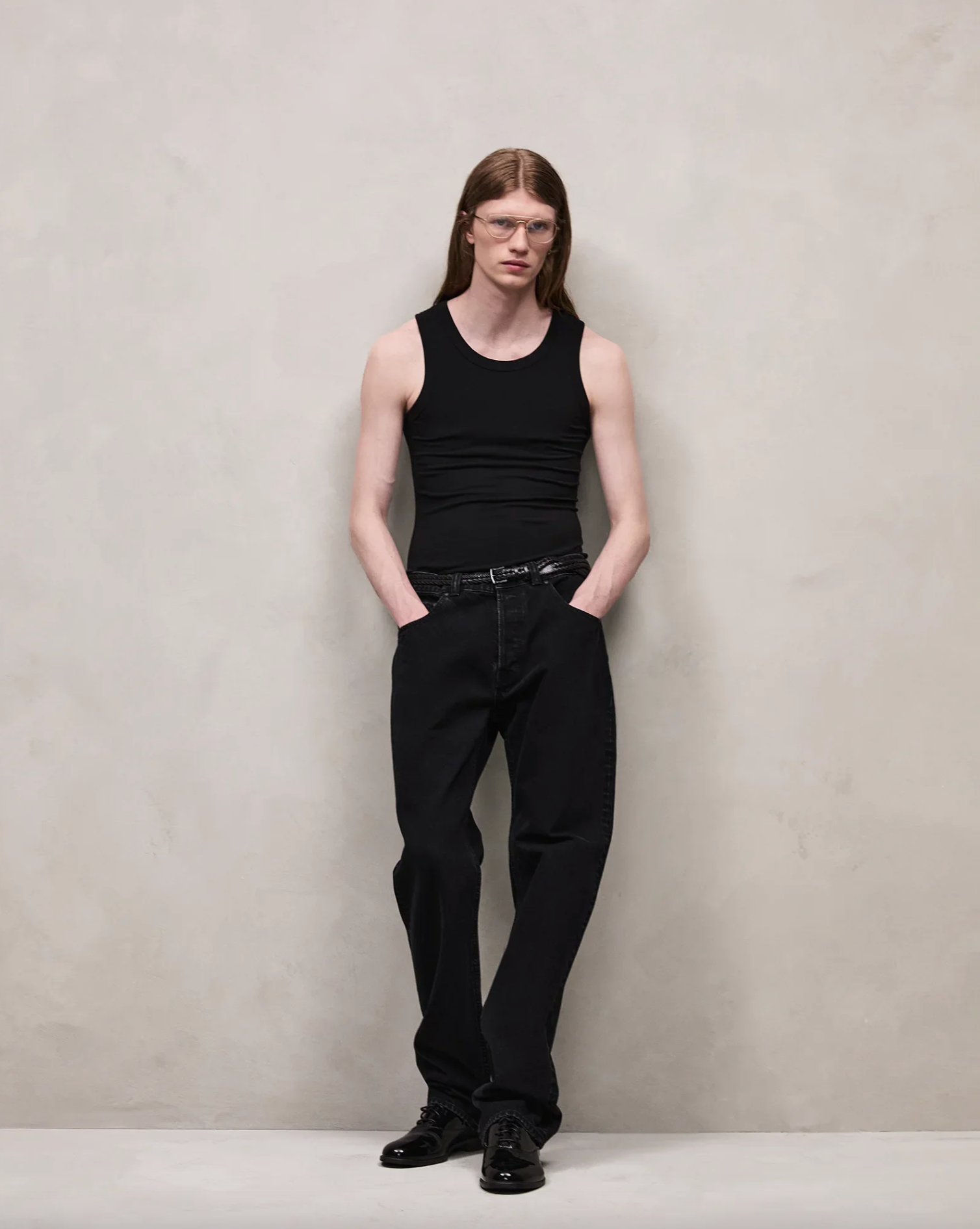 Entire Studio Model wearing a black tank top and pants