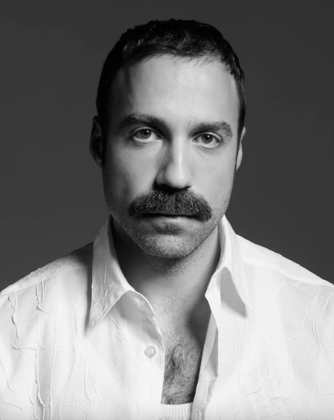 Black and white portrait of Louis Gabriel Nouchi, French fashion designer, wearing LGN textured white shirt.