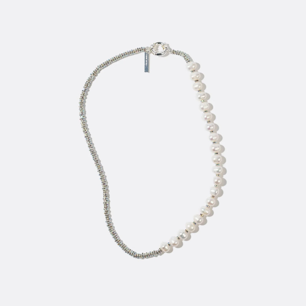 Designer pearl necklace combining delicate crystal detailing with modern asymmetry, expressing a contemporary approach to luxury jewellery and refined craftsmanship.