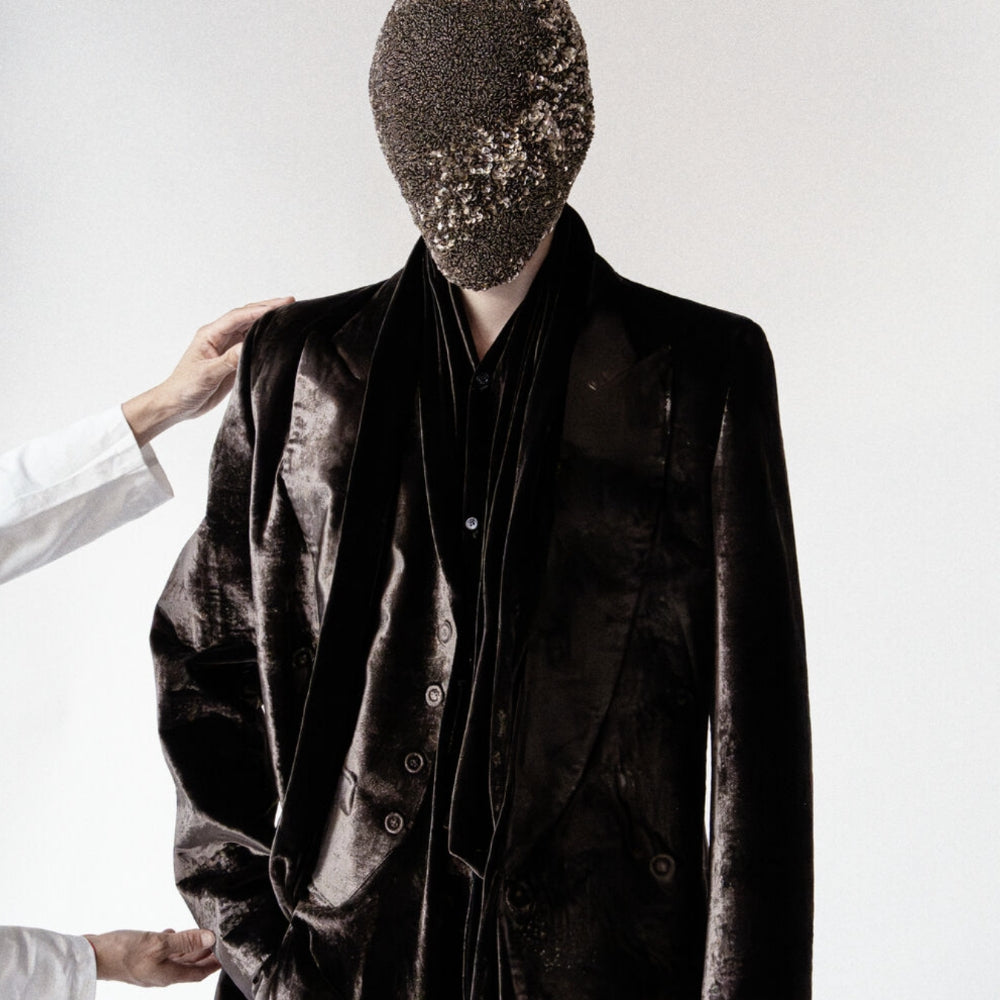 Maison Margiela AW26 fashion editorial featuring a dark velvet tailored suit – shop Maison Margiela at ELLIS ROSCH