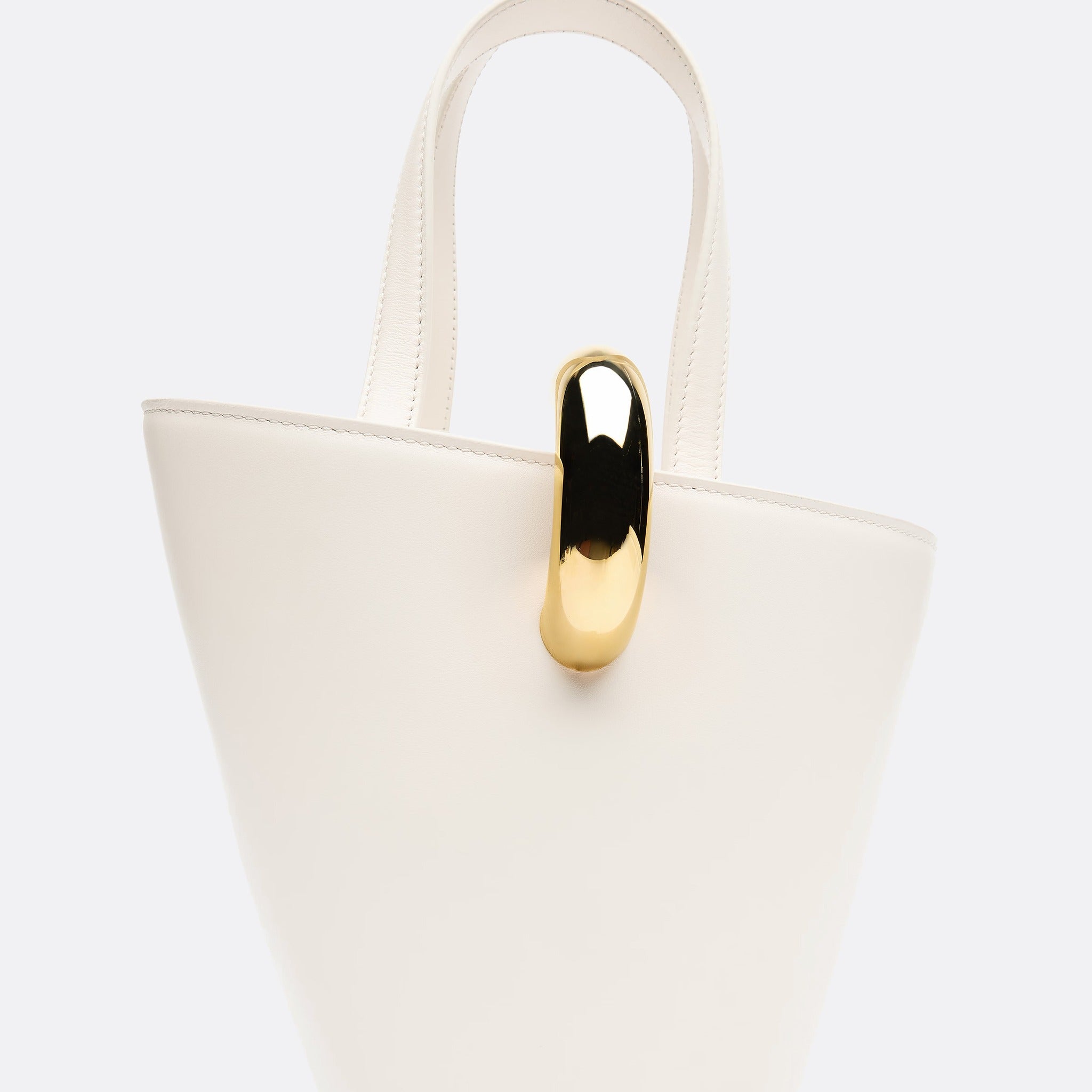 The Small Bambola Asymmetric Mini Bucket Bag from Jacquemus
