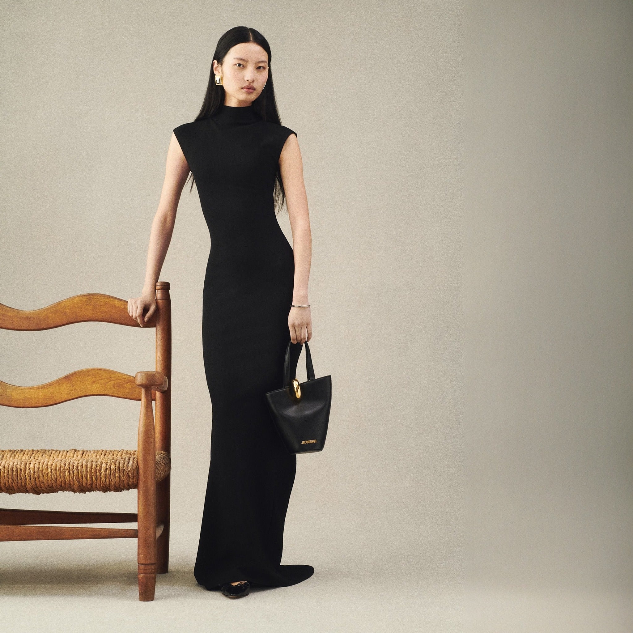 The Small Bambola Asymmetric Mini Bucket Bag from Jacquemus in Black