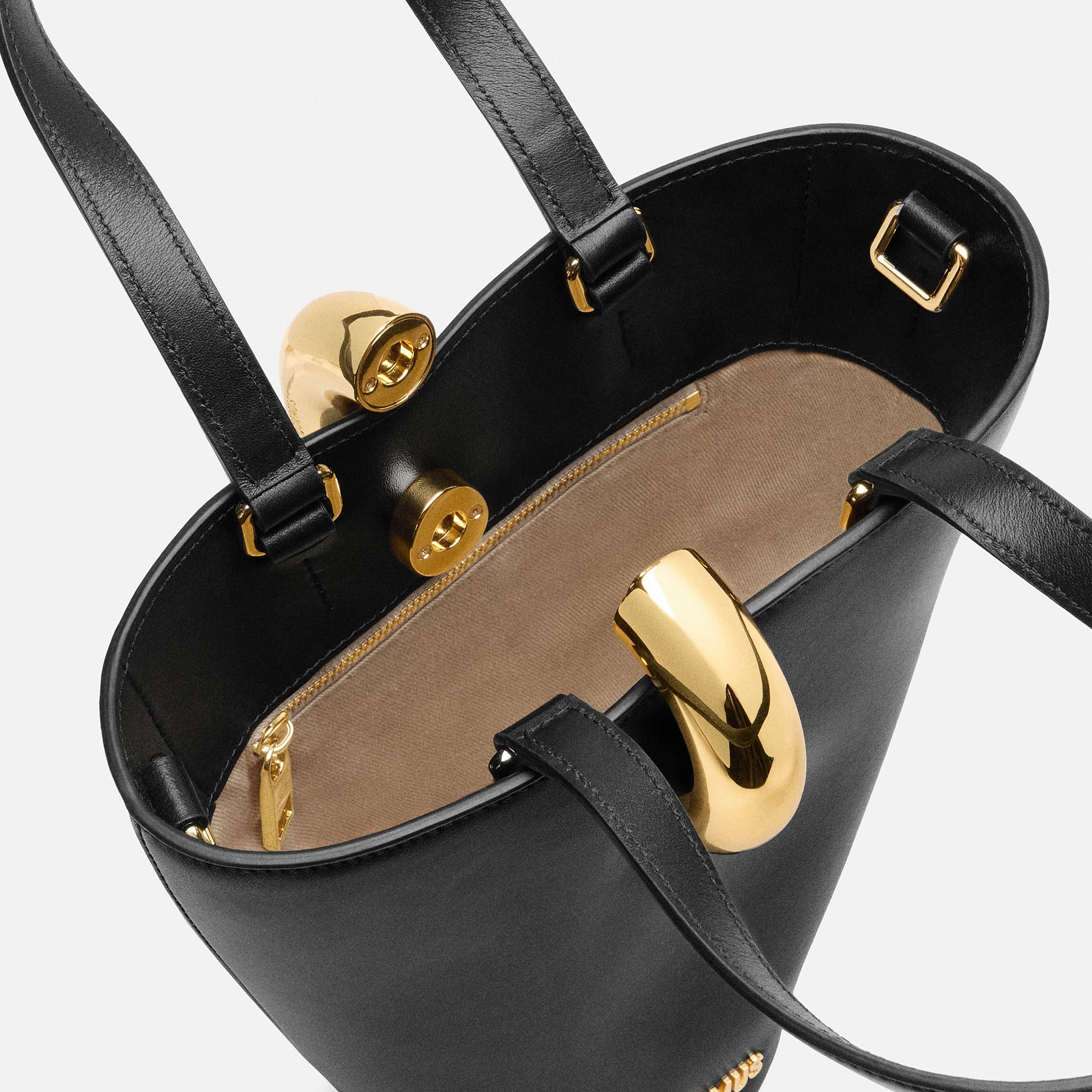 The Small Bambola Asymmetric Mini Bucket Bag from Jacquemus in Black