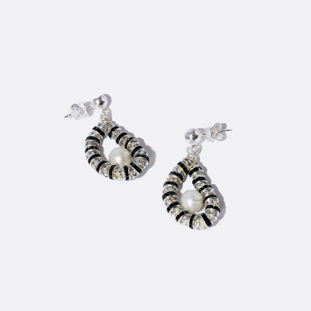 Statement pearl drop earrings featuring sculptural forms and crystal accents, reflecting a modern interpretation of elegance and high-end designer jewellery.